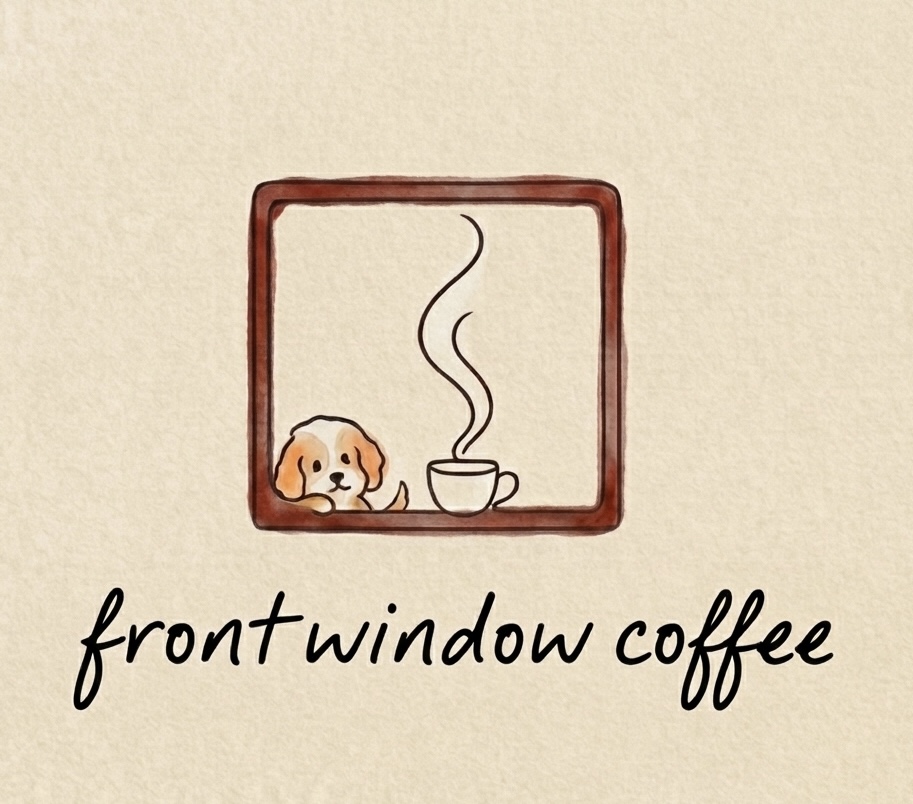 A dog beside a steaming cup in a front window